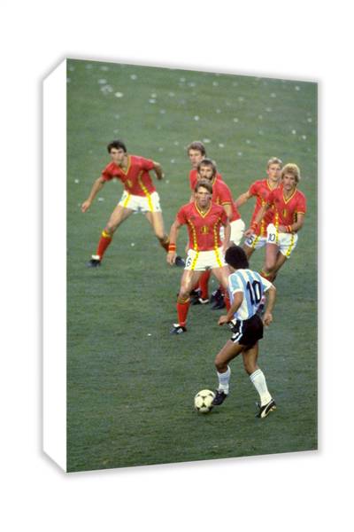 1982 Diego Maradona prepares to take on a posse of Belgian defenders during a World Cup match in Spa