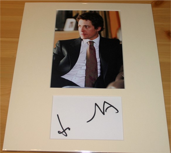 HUGH GRANT SIGNATURE - MOUNTED 12 x 10 INCHES