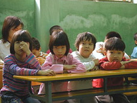 Unbranded Volunteer with disabled children in Hanoi, Vietnam